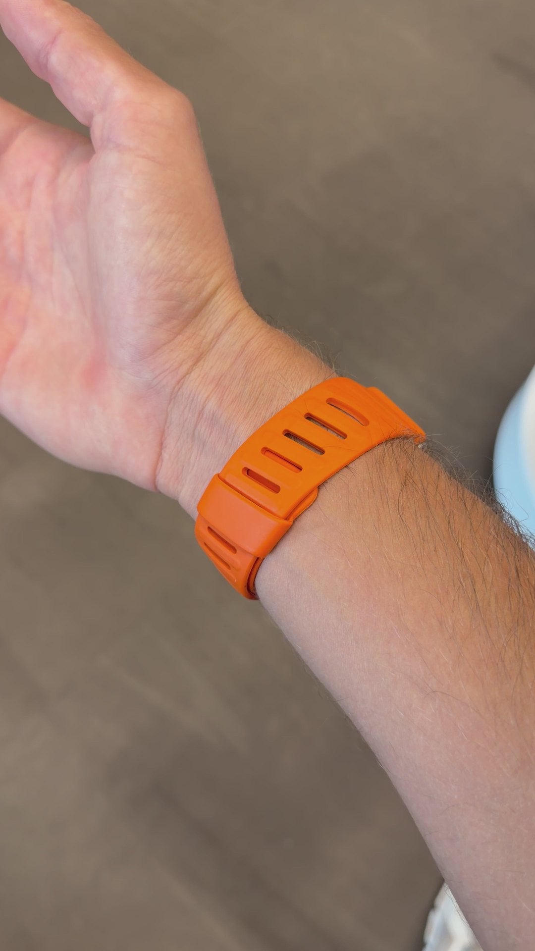 PulseBands orange band worn on the wrist
